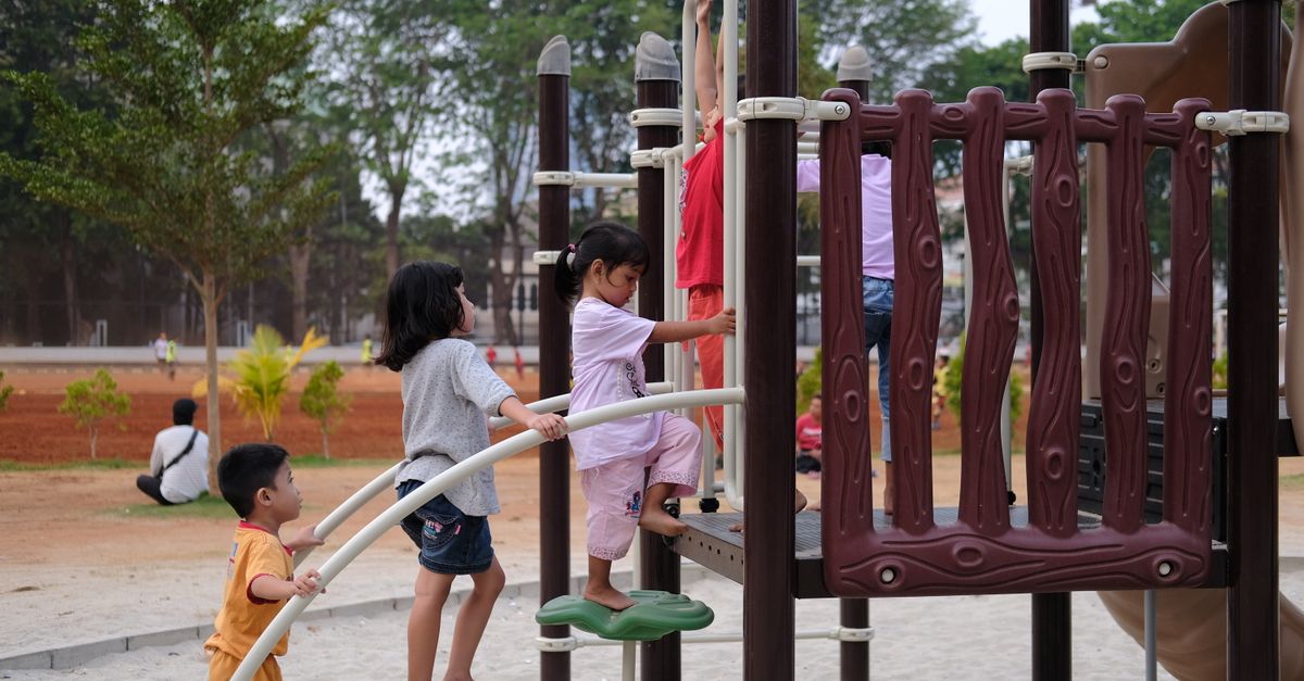 Children enjoying a day at the outdoor playground, climbing and exploring.